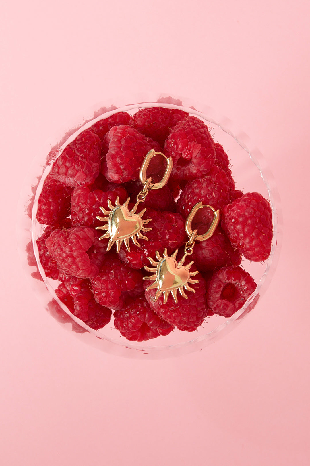 Earrings with dangling hearts and sunbeams