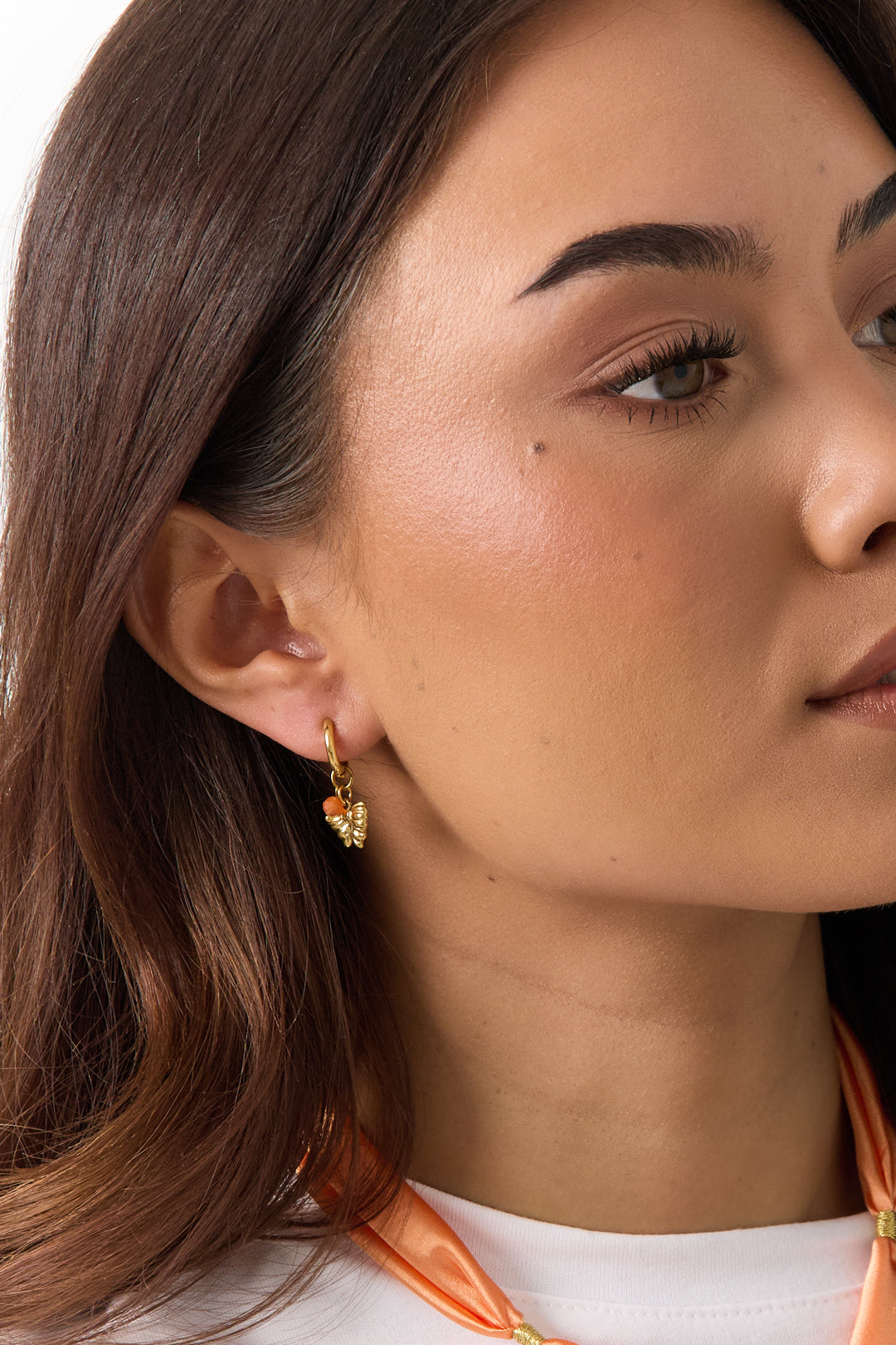 Earrings with hanging bow charm and bead